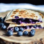 Delicious Blueberry Quesadilla Recipe: A Sweet & Simple Snack You'll Love 2 Blueberry quesadilla stacked on wooden platter