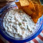 Doritos Dip 2 Creamy Doritos dip served in a blue bowl with nacho chips